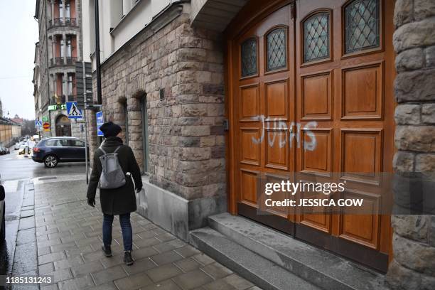 Woman walks past Swedish football player Zlatan Ibrahimovic's residence in Stockholm, where someone sprayed "Judas" on the the door to the building...