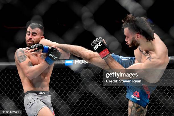 Shane Burgos of the United States kicks Makwan Amirkhani of Finland in the Light Heavyweight bout during UFC 244 at Madison Square Garden on November...