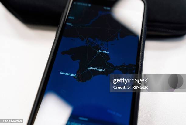 An illustration picture taken on November 28, 2019 in Moscow shows an Apple map with the Crimea peninsula on a smartphone screen. - Ukraine has...
