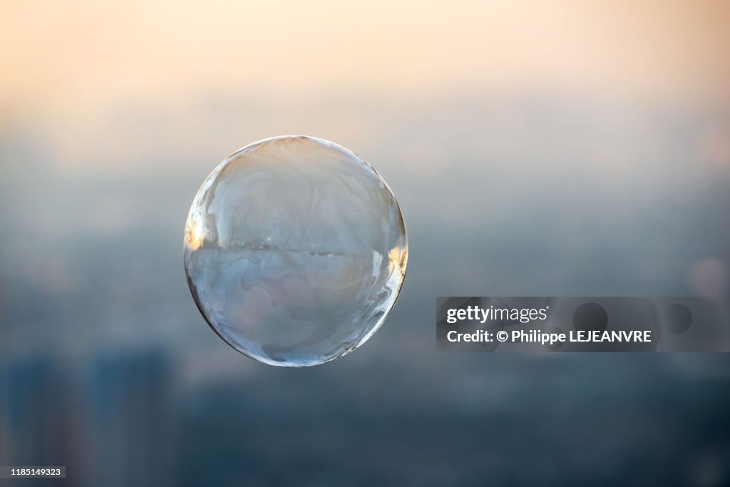 Soap bubble against city aerial view