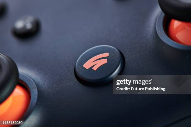 Close-up detail of the Home button on a Google Stadia video game controller with a Night Blue finish, taken on November 27, 2019.