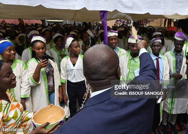 Ivory Coast's Minister of Higher Education and Scientific Research Albert Mabri Toikeusse baptizes the first graduates of the Virtual University of...