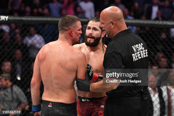 Jorge Masvidal and Nate Diaz interact after the doctor's stoppage in their welterweight bout for the BMF title during the UFC 244 event at Madison...