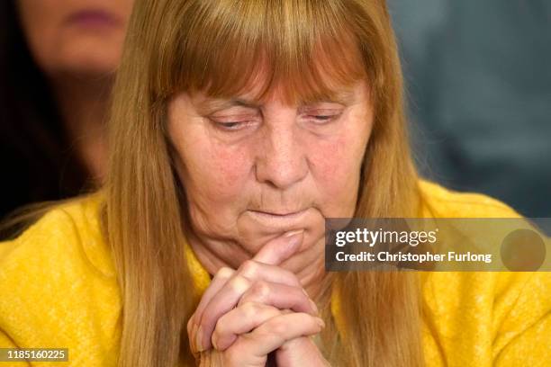 Margaret Aspinall, whose 18-year-old son James was killed in the disaster, looks down during a press conference at the Cunard Building after former...