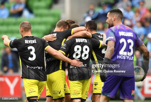 Gary Hooper of the Wellington Phoenix is congratulated by team mates after scoring a goal during the round four A-League match between Melbourne City...