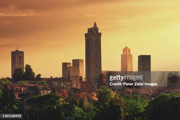 towers of san gimignano in tuscany, italy at sunset - san gimignano stock pictures, royalty-free photos & images