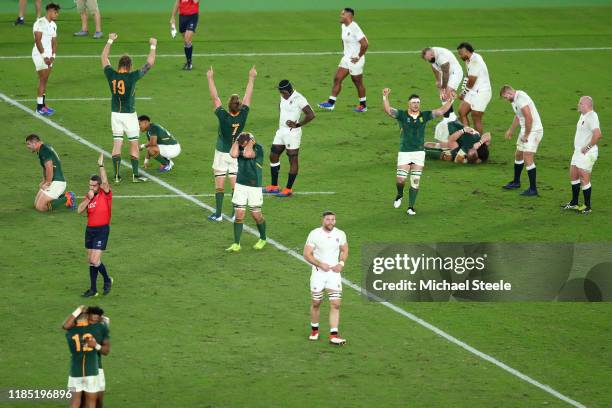 Referee Jerome Garces of France blows the full time whistle as players of South Africa show their jubilation at their side's 32-12 victory over...