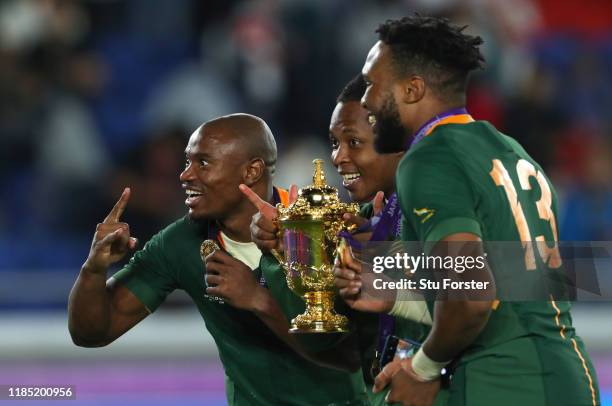 South African players Makazole Mapimpi and Lukhanyo Am celebrate with the trophy after during the Rugby World Cup 2019 Final between England and...