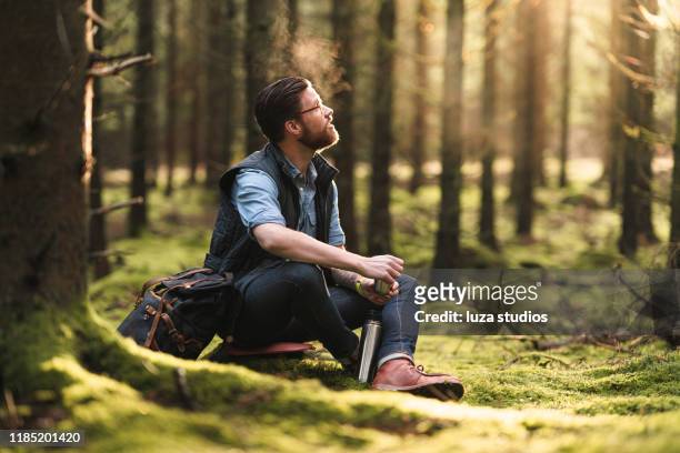 a solo traveler enjoying coffee in the scandinavian nature - breath vapor stock pictures, royalty-free photos & images