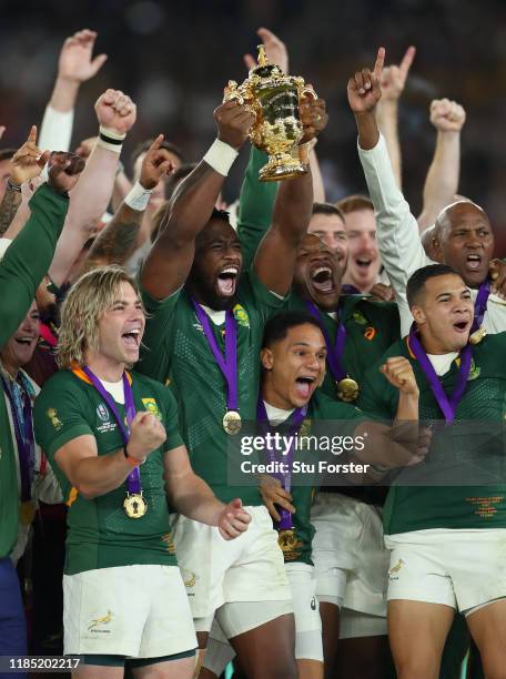 South Africa captain Siya Kolisi lifts the trophy with his team mates Faf de Klerk Herschel Jantjies and Cheslin Kolbe after the Rugby World Cup 2019...