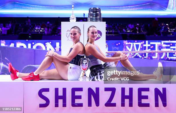 Timea Babos of Hungary and Kristina Mladenovic of France celebrate with the trophy after winning their Women's Doubles final match against Su-Wei...