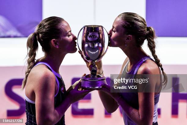 Timea Babos of Hungary and Kristina Mladenovic of France celebrate with the trophy after winning their Women's Doubles final match against Su-Wei...