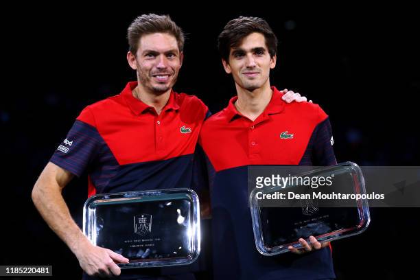 Pierre-Hugues Herbert and Nicolas Mahut of France pose with the winners trophy after victory in their Final match against Karen Khachanov and Andrey...