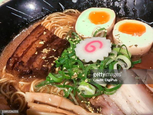 tonkotsu ramen w/ pork, egg, gold leaf, kamaboko and long onion toppings - char siu pork stock pictures, royalty-free photos & images