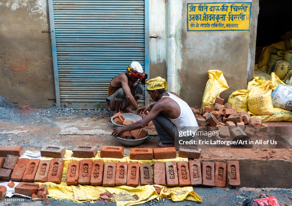 Indian workers building a house with bricks, Rajasthan, Nawalgarh, India...
