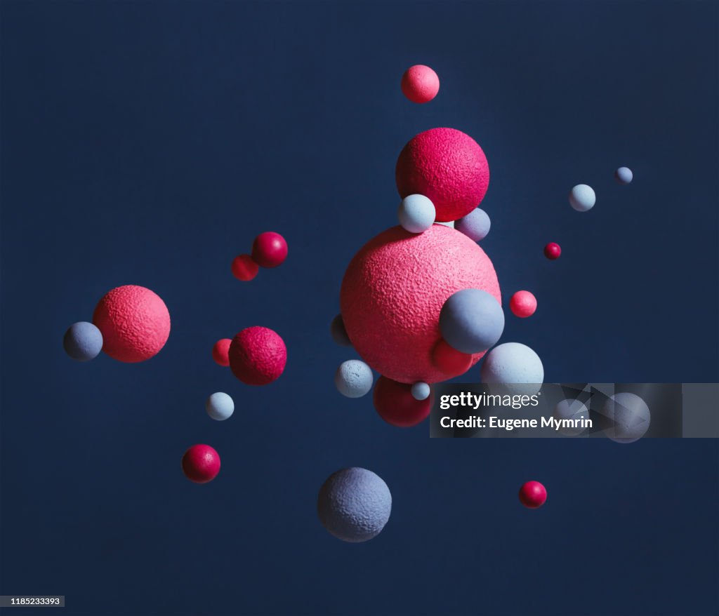 Abstract multi-colored spheres on blue background