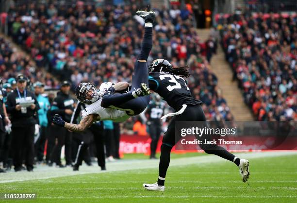 Kenny Stills of the Houston Texans makes a catch over Tre Herndon of the Jacksonville Jaguars during the NFL match between the Houston Texans...