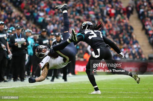 Kenny Stills of the Houston Texans makes a catch over Tre Herndon of the Jacksonville Jaguars during the NFL match between the Houston Texans...