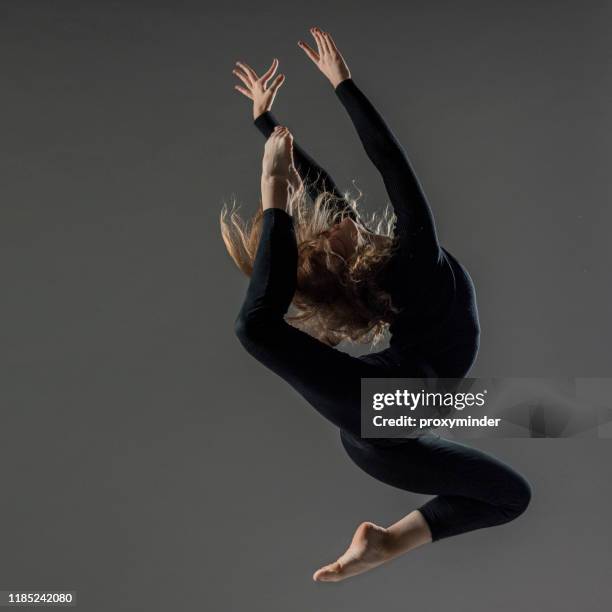 dancer on gray background - ballet black and white stock pictures, royalty-free photos & images