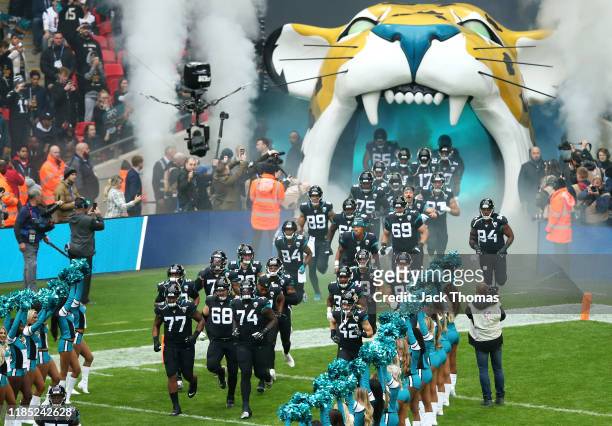 The Jacksonville Jaguars make their way out onto the pitch prior to the NFL match between the Houston Texans and Jacksonville Jaguars at Wembley...
