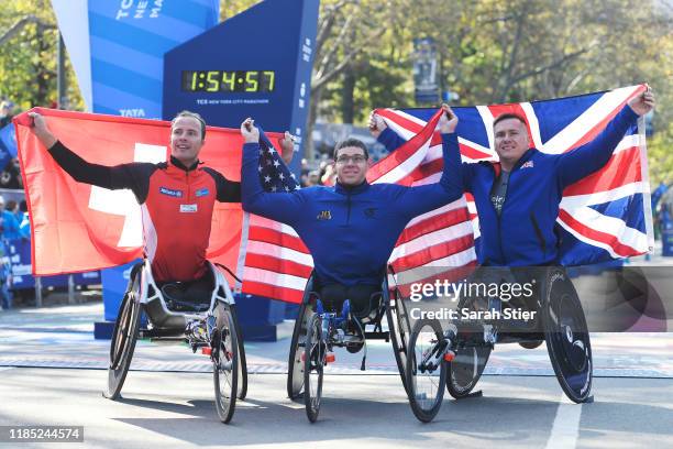 Marcel Hug of Switzerland, Daniel Romanchuk of the United States, and David Weir of Great Britain pose for a photo after taking the top three spots...