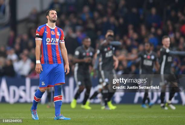 Luka Milivojević of Crystal Palace reacts as Jamie Vardy of Leicester City celebrates after scoring his sides second goal during the Premier League...