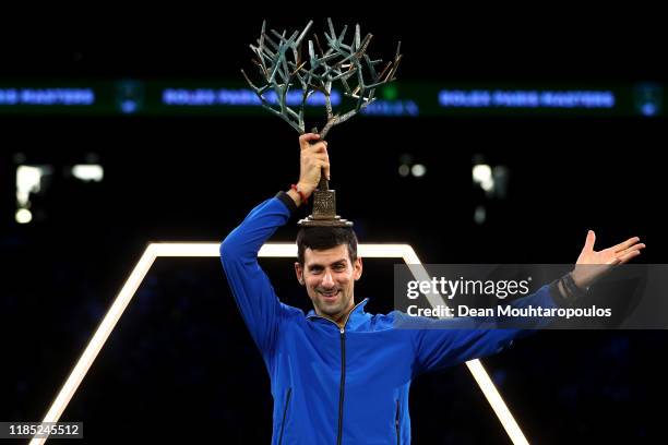 Novak Djokovic of Serbia celebrates with the trophy after victory in the Men's Singles Final match against Denis Shapovalov of Canada on day 7 of the...