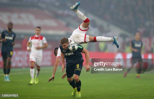 Simon Terodde of Koeln is challenged by Niko Giesselmann of Duesseldorf during the Bundesliga match between Fortuna Duesseldorf and 1. FC Koeln at...