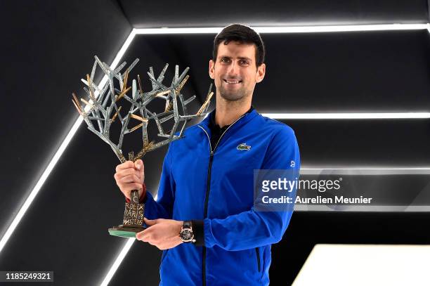 Novak Djokovic of Serbia poses with the trophy after winning his Men's Singles Final match against Denis Shapovalov of Canada on day 7 of the Rolex...