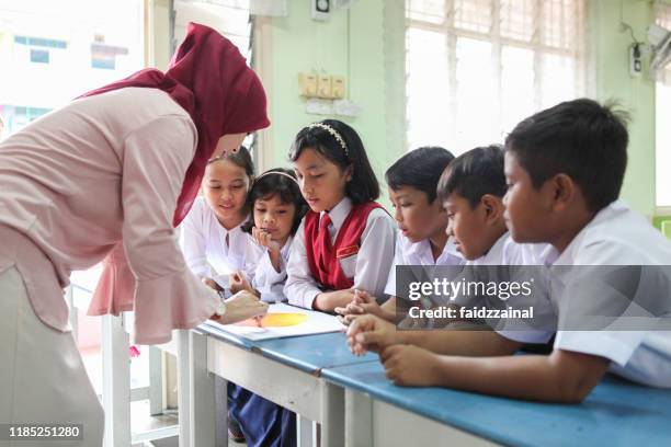 group discussion of school children in a classroom - malaysia school stock pictures, royalty-free photos & images