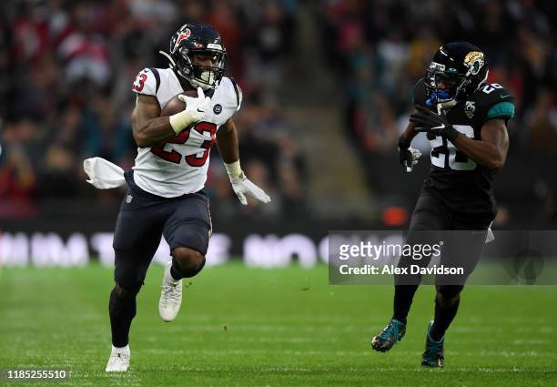 Carlos Hyde of Houston Texans gets past Jarrod Wilson of Jacksonville Jaguars during the NFL game between Houston Texans and Jacksonville Jaguars at...