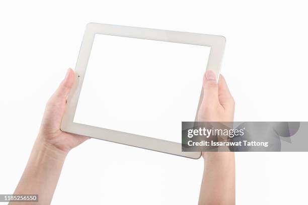 female hands holding a tablet touch computer gadget with isolated screen - ipad hand foto e immagini stock