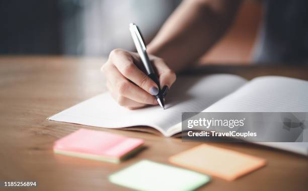 business woman working at office with documents on his desk, business woman holding pens and papers making notes in documents on the table, hands of financial manager taking notes - diary photos et images de collection