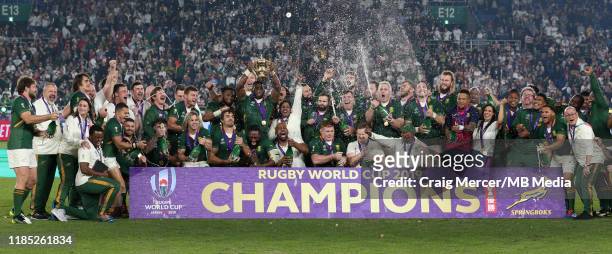 Siya Kolisi of South Africa lifts the Webb Ellis Cup and celebrates with team mates after their side win the Rugby World Cup 2019 Final between...