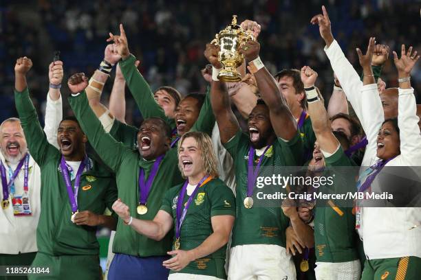 Siya Kolisi of South Africa lifts the Webb Ellis Cup and celebrates with team mates after their side win the Rugby World Cup 2019 Final between...