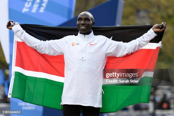 Geoffrey Kamworor of Kenya poses with the Kenyan flag after winning the Men's Division of the 2019 TCS New York City Marathon on November 03, 2019 in...