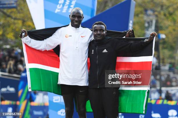 Geoffrey Kamworor and Joyciline Jepkosgei of Kenya pose with the Kenyan flag after winning the Mens' and Womens' Division of the 2019 TCS New York...