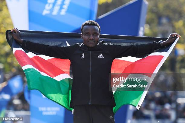 Joyciline Jepkosgei of Kenya poses with the Kenyan flag after winning the Womens' Division of the 2019 TCS New York City Marathon on November 03,...