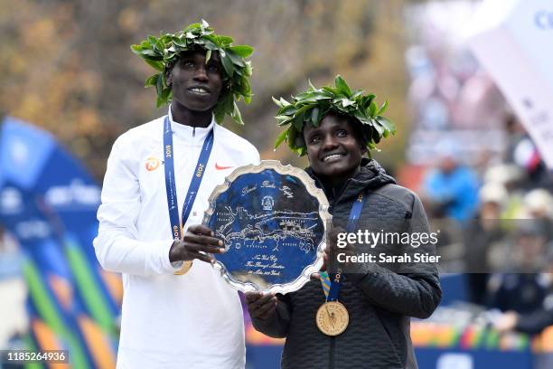 Geoffrey Kamworor and Joyciline Jepkosgei of Kenya pose with the trophy after winning the Mens' and Womens' Division of the 2019 TCS New York City...