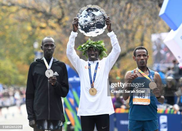 Second-place finisher Albert Korir of Kenya, first-place finisher Geoffrey Kamworor of Kenya, and third-place finisher Girma Bekele Gebre of Ethiopia...