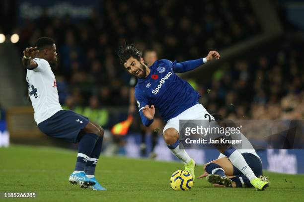 Andre Gomes of Everton is tackled by Son Heung-Min of Tottenham Hotspur, before colliding with Serge Aurier of Tottenham Hotspur during the Premier...