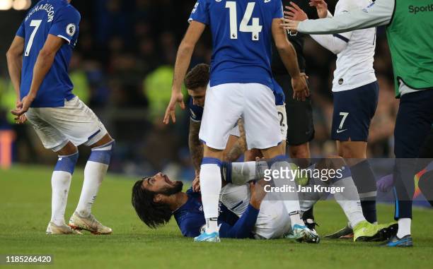 Andre Gomes of Everton reacts after being tackled by Son Heung-Min of Tottenham Hotspur during the Premier League match between Everton FC and...