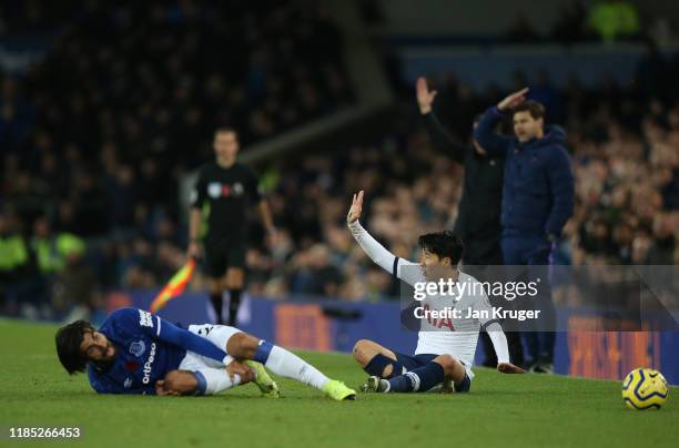 Son Heung-Min of Tottenham Hotspur apologises after a tackle on Andre Gomes of Everton during the Premier League match between Everton FC and...