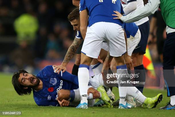 Andre Gomes of Everton reacts after being tackled by Son Heung-Min of Tottenham Hotspur during the Premier League match between Everton FC and...