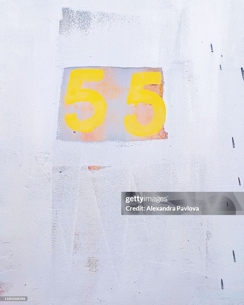 Close-up of Number 55 in bright colors on a wall / door