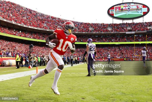 Tyreek Hill of the Kansas City Chiefs celebrates catching a 40-yard touchdown pass against the Minnesota Vikings during the first quarter at...