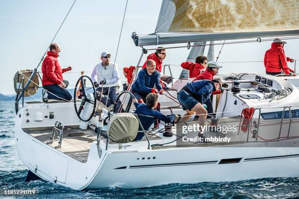 sailing crew on sailboat on regatta - rudder stock pictures, royalty-free photos & images