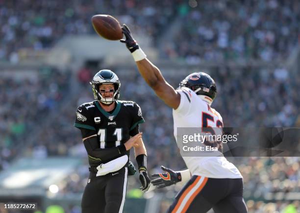 Carson Wentz of the Philadelphia Eagles passes the ball as Khalil Mack of the Chicago Bears bats it down in the first quarter at Lincoln Financial...