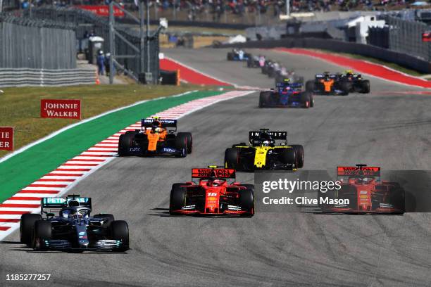 Lewis Hamilton of Great Britain driving the Mercedes AMG Petronas F1 Team Mercedes W10 leads Charles Leclerc of Monaco driving the Scuderia Ferrari...