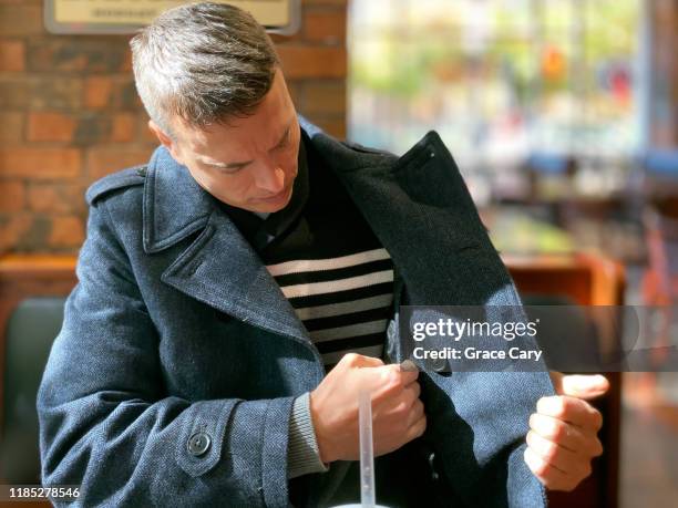 man checks interior coat pocket - ficka bildbanksfoton och bilder